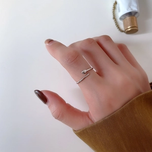 Detail of minimalist 925 sterling silver teardrop ring worn on a finger