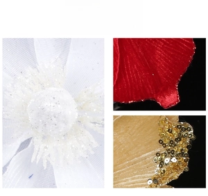 Close-up of glitter mesh, red velvet petals and gold sequin Christmas flower details