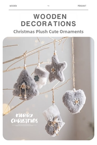 Detail of gray and white plush Christmas ornaments hanging on a wooden branch