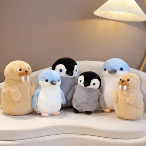 Plush penguin and walrus stuffed animals set on a cozy sofa in a warm home setting