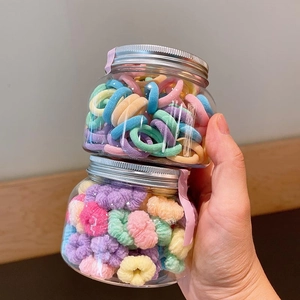 Colorful elastic hair ties for girls in transparent jars with pastel macaron shades