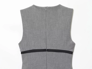 Detail view of smooth grey satin dress featuring a back invisible zipper and black bow ribbon
