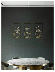 Detail of three-piece golden metal wire coffee cup wall art on dark textured wall