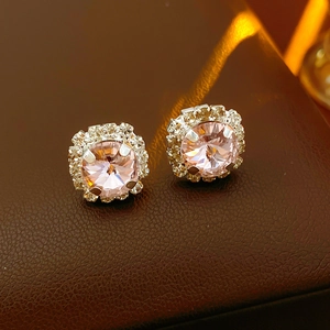 Detail of silver square stud earrings with pink crystal and white rhinestones