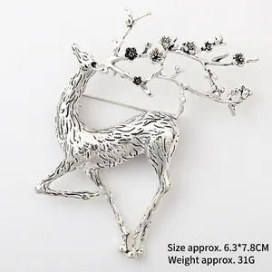 Detail view of vintage silver elk brooch with plum blossom antlers measuring 6.3x7.8cm