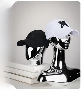Detail of adjustable cotton baseball caps with 3D embroidered X logo in black and white