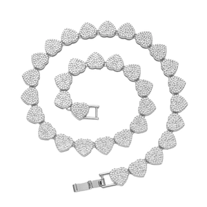 Silver iced out heart-shaped Cuban link necklace with sparkling pavé crystals on white background