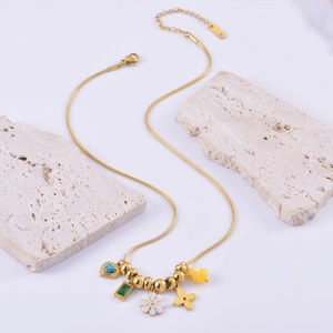 Golden snake chain necklace with turquoise heart, daisy, and emerald pendants