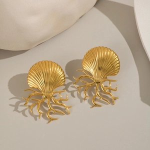 Gold ocean-style earrings featuring shell and coral designs on a minimalist background