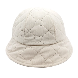 Close-up of beige corduroy bucket hat with heart quilted patterns for autumn and winter