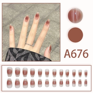 Macro detail of amber cat eye gradient press-on nails with glitter tips set A676