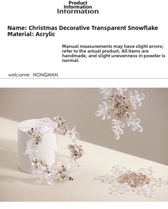 Macro view of clear acrylic snowflake and wreath ornament with sparkly gold and silver glitter