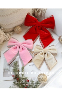 Close-up of velvet Christmas bows in red and pink with glittering edges for decor