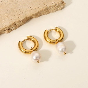 Close-up of 18K gold stainless steel hoop earrings with white natural freshwater pearls