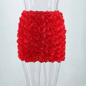 Detailed view of red mini skirt featuring 3D rose flower decorations and satin texture