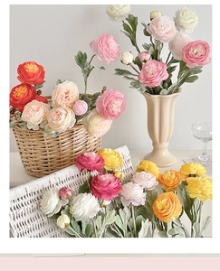 Artistic arrangement of artificial ranunculus flowers in pastel colors for home decor