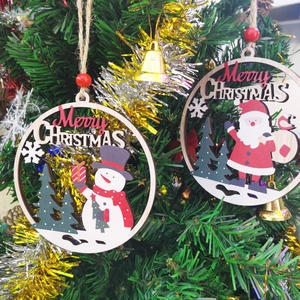 Close-up of wooden Christmas ornaments with Santa and snowman on a decorated tree