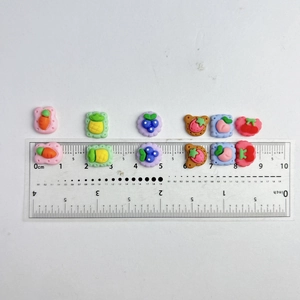 Miniature resin fruit and cookie charms for DIY nail art and crafts with ruler measurement