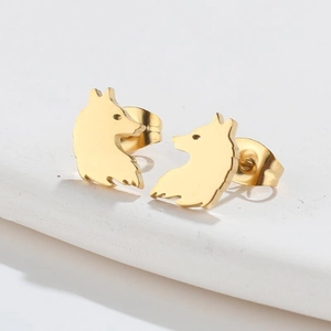 Macro detail of golden wolf head silhouette earrings crafted in durable stainless steel