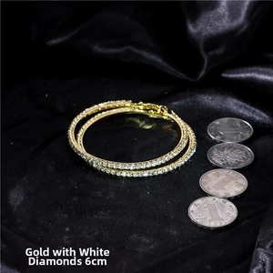 Detailed view of 6cm oversized gold hoop earrings with micro-pave white crystals