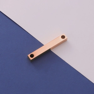 Macro shot of rose gold titanium steel 3D rectangular bar pendant with dual holes
