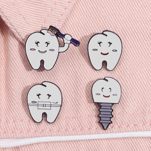 Cute cartoon tooth enamel pins set on pink denim background for shirt decoration