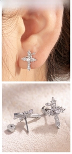Detailed view of silver gothic cross earrings with cubic zirconia and screw back