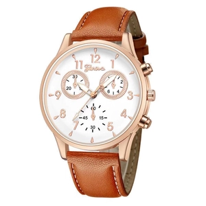 Detail of rose gold watch case with white dial and stitched brown leather strap