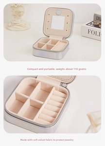 Detail of portable silver jewelry box with built-in mirror and velvet ring organizer