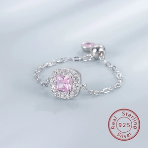 Macro detail of S925 sterling silver chain ring with pink square zircon and slider bead