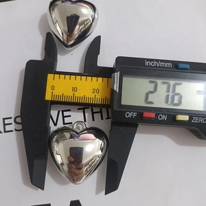 Detail view of silver heart pendant measuring 27.6mm width with a high mirror finish