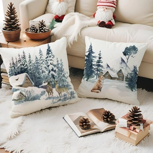 Close-up of winter watercolor fox and deer prints on linen Christmas cushion covers
