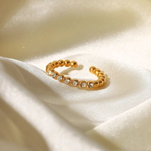 Macro shot of 18K gold plated beaded open ring with sparkling white cubic zirconia