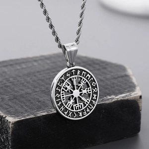 Macro shot of silver Viking Vegvisir compass pendant with ancient runic alphabet details