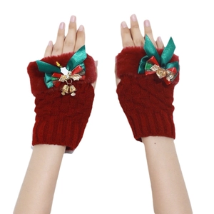 Christmas red fingerless knit gloves with green bow and gold bell on white background