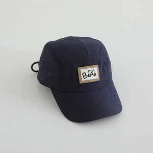 Detail of dark blue outdoor camper cap with breathable holes and BEAR letter patch