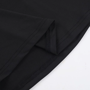 Close-up of double-needle stitching on the hem of a black slim-fit knitted dress