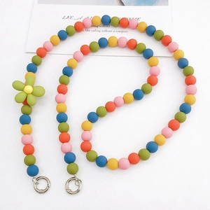 Colorful resin bead crossbody phone chain with rubberized floral charm on white background