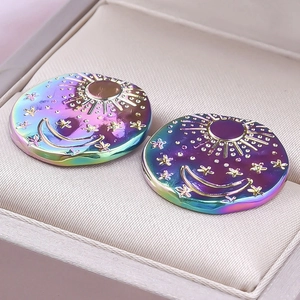Macro view of rainbow-plated 304 stainless steel earrings with sun and moon motifs