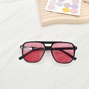 Detail of square vintage pilot sunglasses with black double bridge frame and pink lenses