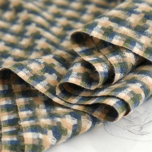 Close-up of thick plaid woven fabric with soft texture in navy blue and forest green