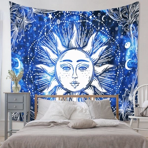 Detail of bohemian sun and moon tapestry displayed as a bedroom headboard backdrop