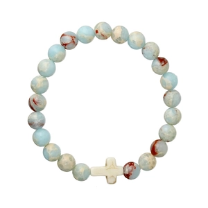 Close-up of turquoise and agate beaded bracelet with a white stone cross bead