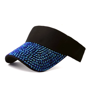 Detailed side view of a black visor cap with sparkling blue rhinestones on the brim