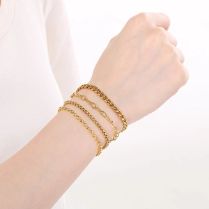 Close-up of set of 4 minimalist 18K gold plated stainless steel chain bracelets on wrist