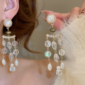 Close-up of pearl and crystal tassel earrings featuring elegant vintage palace style