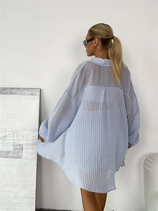 Rear view of a light blue textured striped shirt with a loose fit and semi-sheer fabric