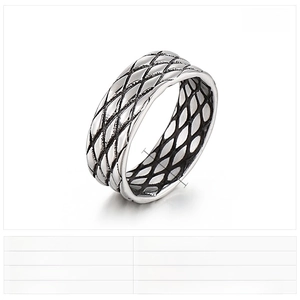 Detail shot of vintage stainless steel rings with textured fish scale pattern finish