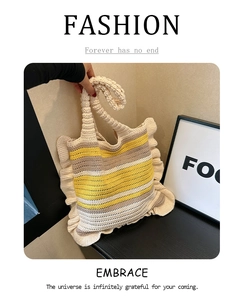 Detail showing the colorful striped handmade knit tote bag with elegant ruffled edges