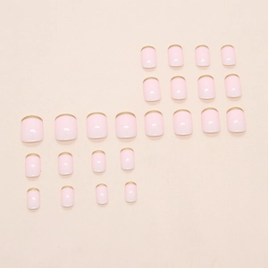 Elegant light pink French press-on nails with golden edges in a 24-piece assorted set